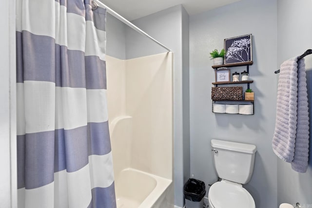 bathroom featuring shower / tub combo with curtain and toilet