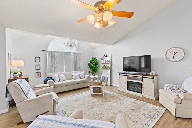 living room featuring lofted ceiling, ceiling fan, and light hardwood / wood-style flooring