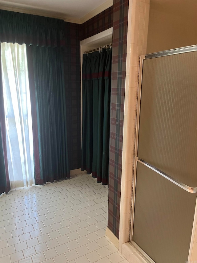 bathroom with walk in shower and tile patterned flooring