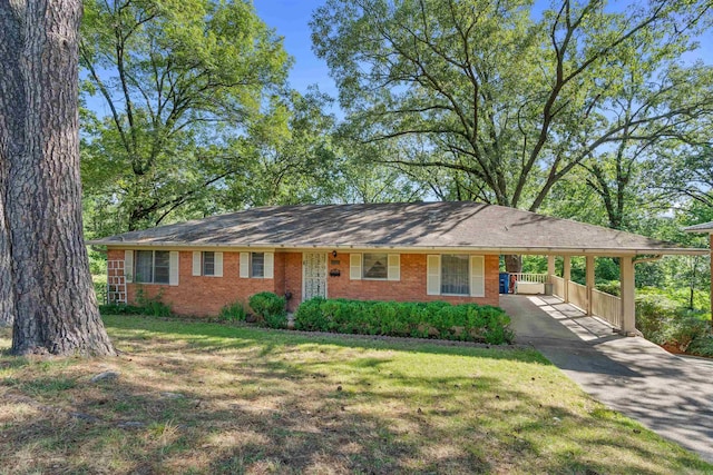 ranch-style house featuring a carport and a front lawn