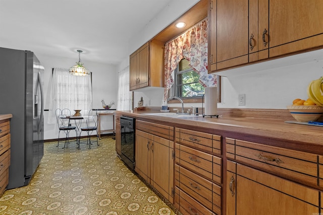 kitchen with stainless steel refrigerator with ice dispenser, tile patterned floors, black dishwasher, pendant lighting, and sink