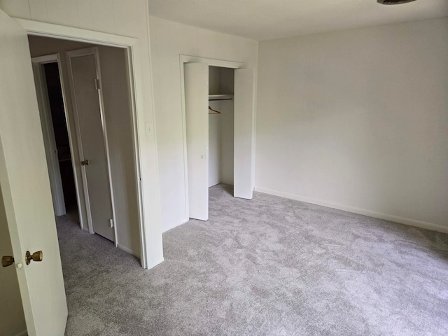 unfurnished bedroom with a closet and carpet floors