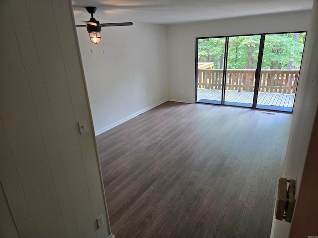 spare room with ceiling fan and dark hardwood / wood-style flooring