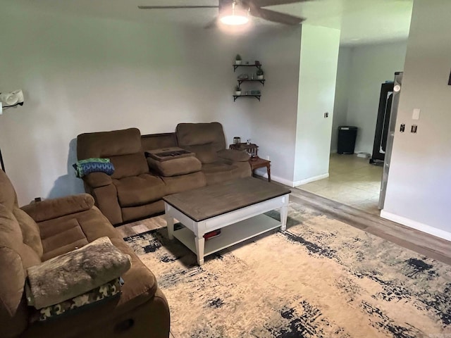 living room featuring ceiling fan and hardwood / wood-style floors