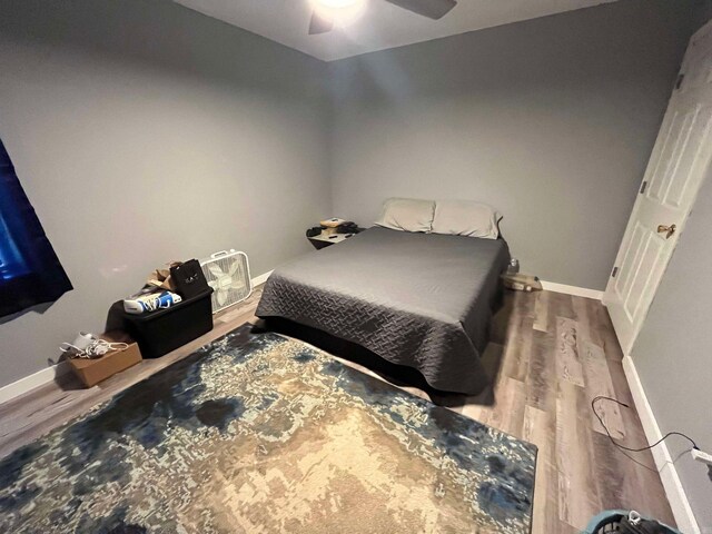 bedroom featuring hardwood / wood-style floors and ceiling fan