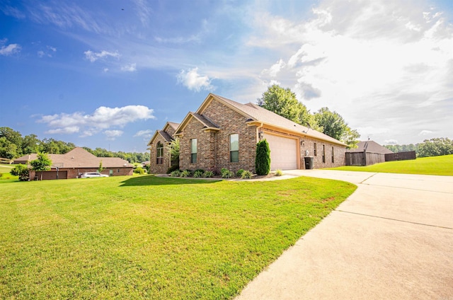 view of front of property featuring a front lawn and a garage