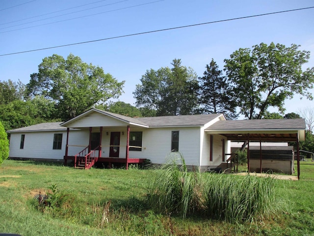 single story home with a carport, a porch, and a front yard