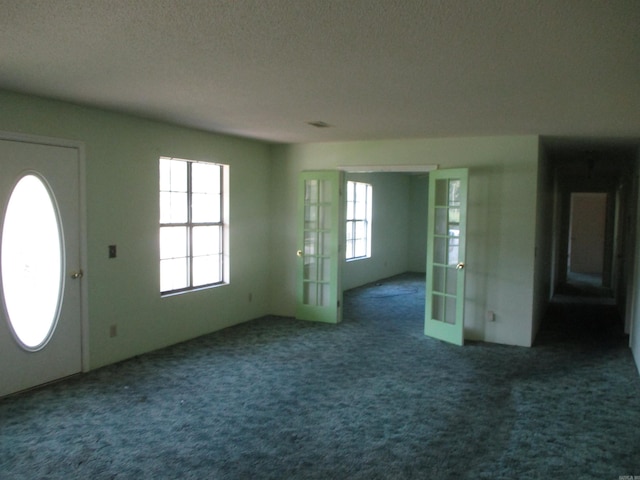 carpeted entryway featuring french doors