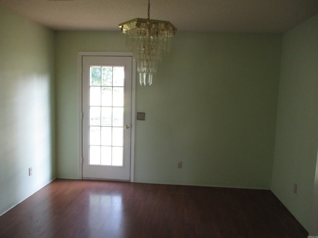 doorway featuring a chandelier and hardwood / wood-style flooring