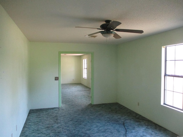 unfurnished room featuring ceiling fan, carpet, and plenty of natural light