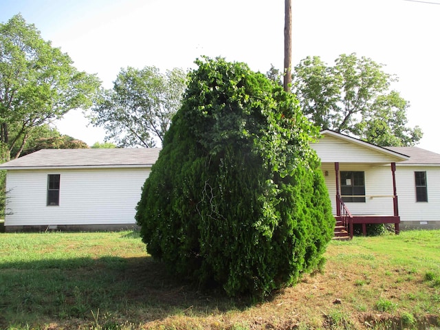 view of side of property with a yard