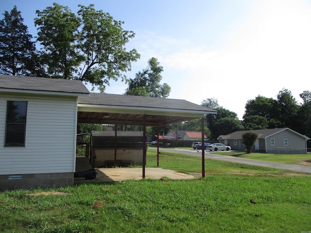 view of vehicle parking featuring a lawn