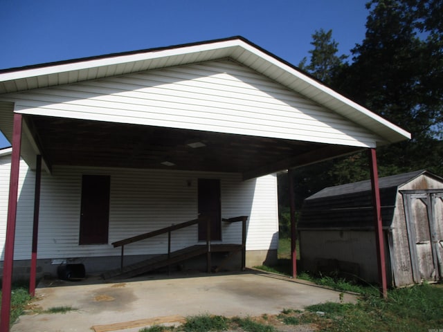 view of front of property with a carport and a storage shed