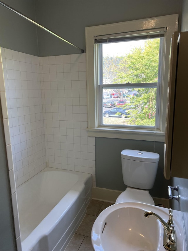 bathroom with sink, tile patterned floors, and washtub / shower combination