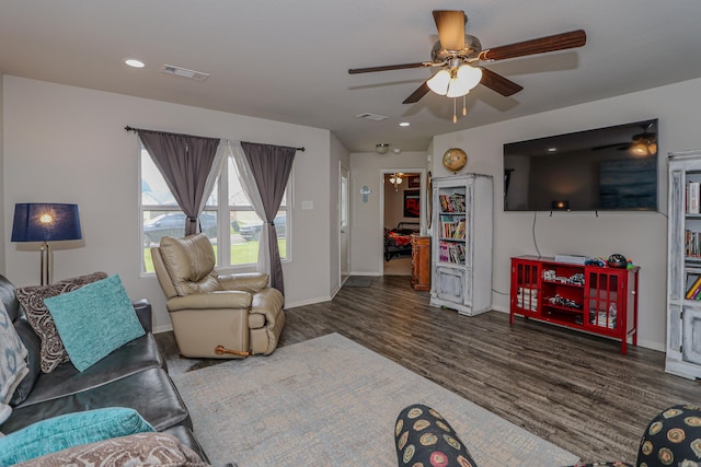 living room featuring dark hardwood / wood-style floors and ceiling fan