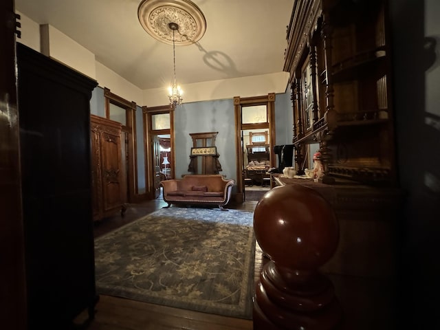 sitting room with hardwood / wood-style flooring and a chandelier