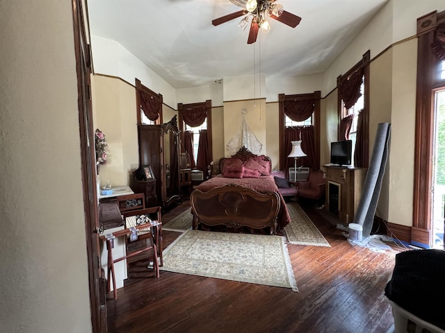 bedroom with ceiling fan and dark hardwood / wood-style floors