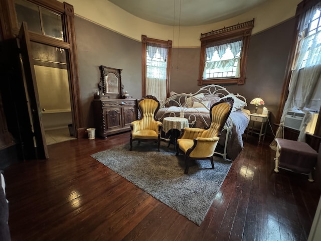 bedroom featuring cooling unit and dark hardwood / wood-style flooring