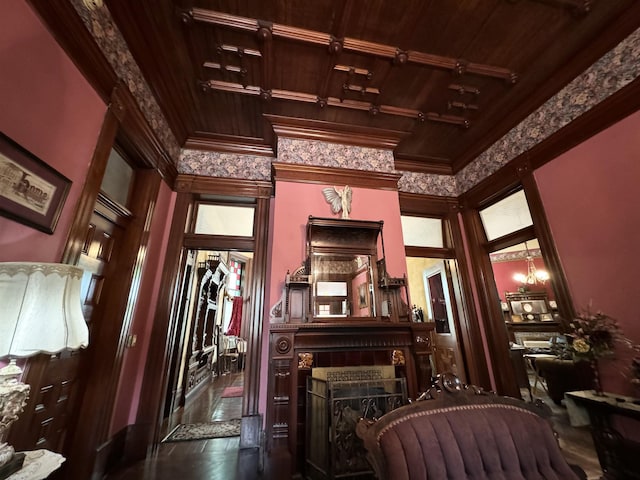 living area featuring a fireplace, ornamental molding, and track lighting