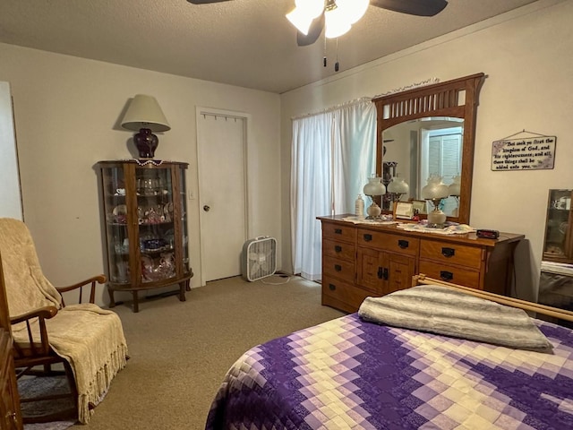 bedroom featuring a textured ceiling, carpet floors, and ceiling fan