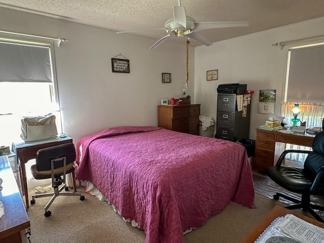 bedroom with carpet flooring, a textured ceiling, and ceiling fan