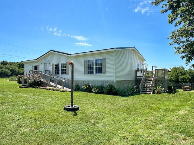 view of side of home with a wooden deck and a yard