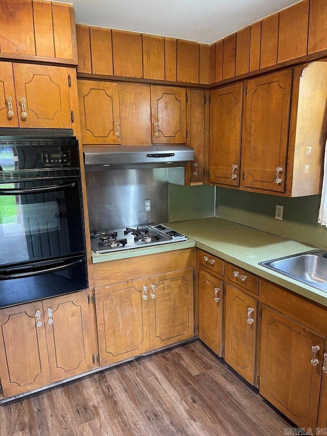 kitchen with oven, white gas cooktop, and dark wood-type flooring