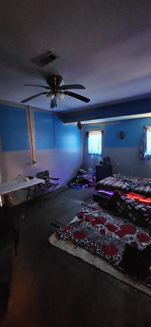 bedroom with a textured ceiling and ceiling fan