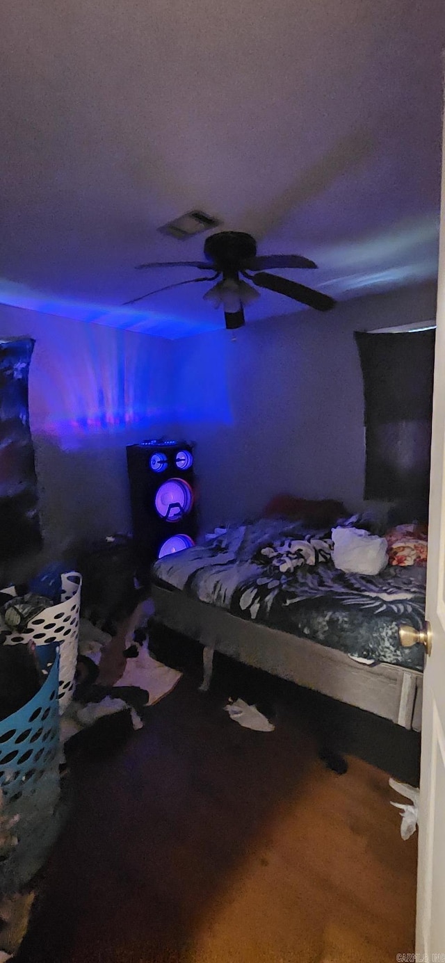 bedroom with wood-type flooring and ceiling fan