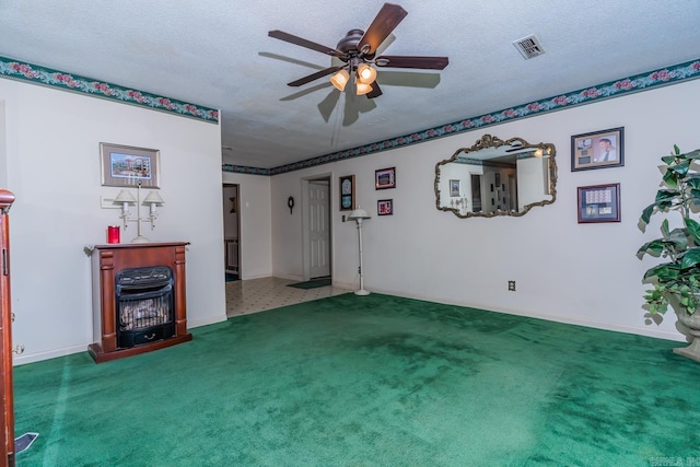 living room with carpet flooring, ceiling fan, and a textured ceiling