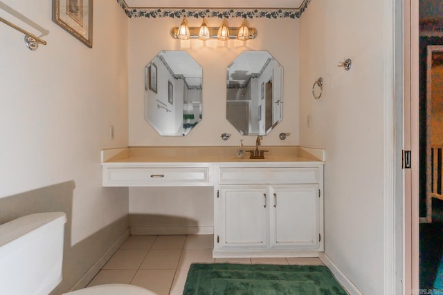 bathroom featuring tile patterned flooring, vanity, and toilet