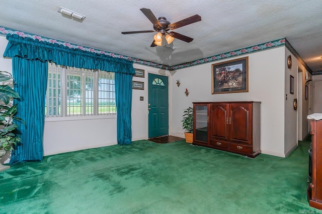 interior space with carpet, a textured ceiling, and ceiling fan