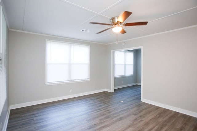 empty room with crown molding, dark hardwood / wood-style floors, and ceiling fan