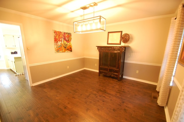 unfurnished dining area featuring crown molding and dark wood-type flooring