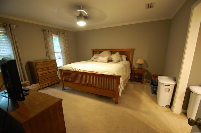 carpeted bedroom with crown molding and ceiling fan