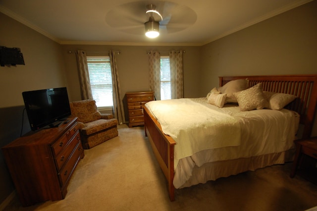 carpeted bedroom featuring crown molding and ceiling fan