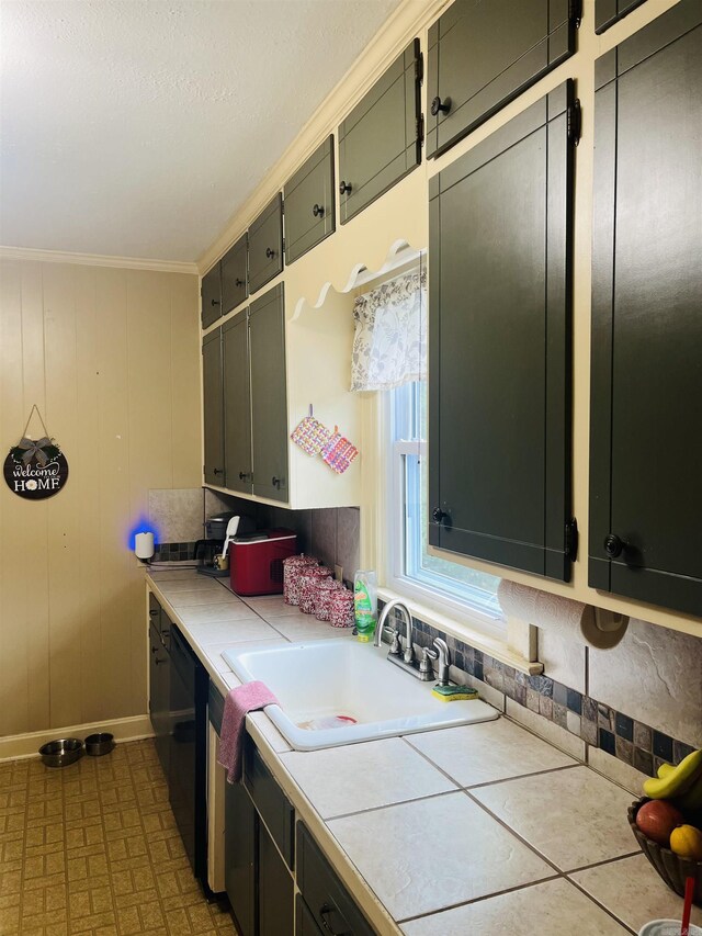 kitchen with sink, tile patterned floors, tile countertops, and crown molding