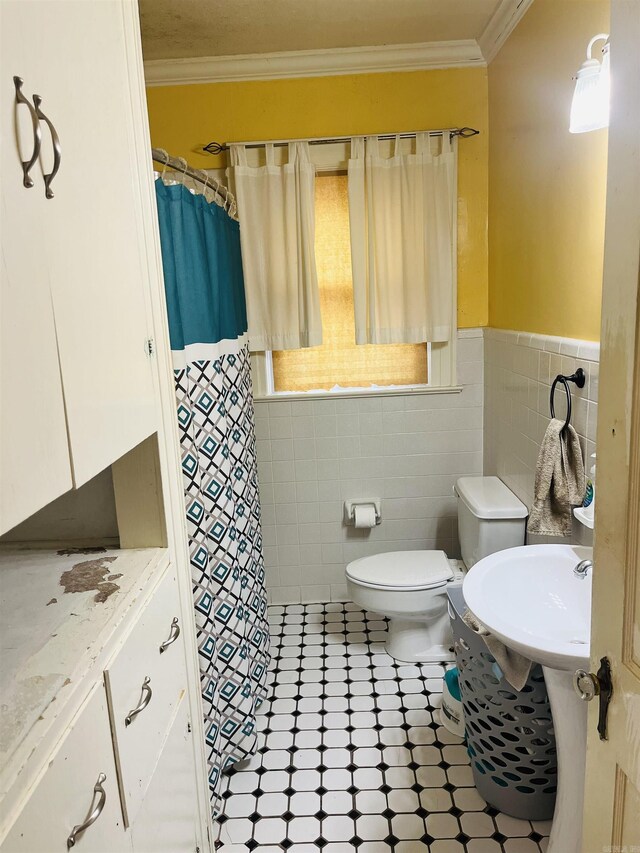 bathroom featuring tile patterned flooring, toilet, tile walls, decorative backsplash, and ornamental molding