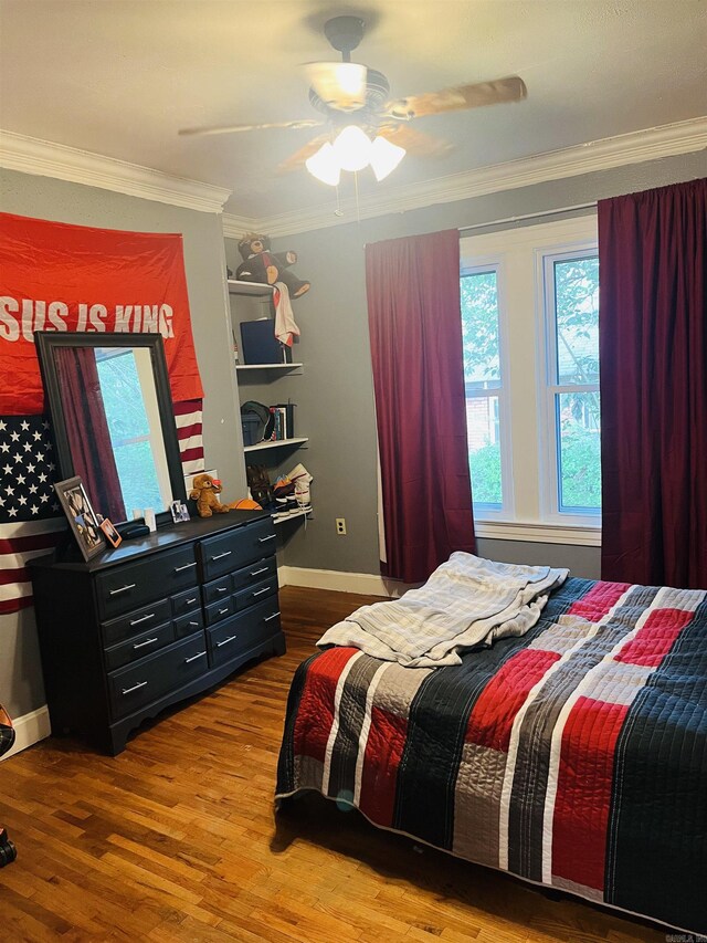 bedroom with wood-type flooring, ornamental molding, and ceiling fan