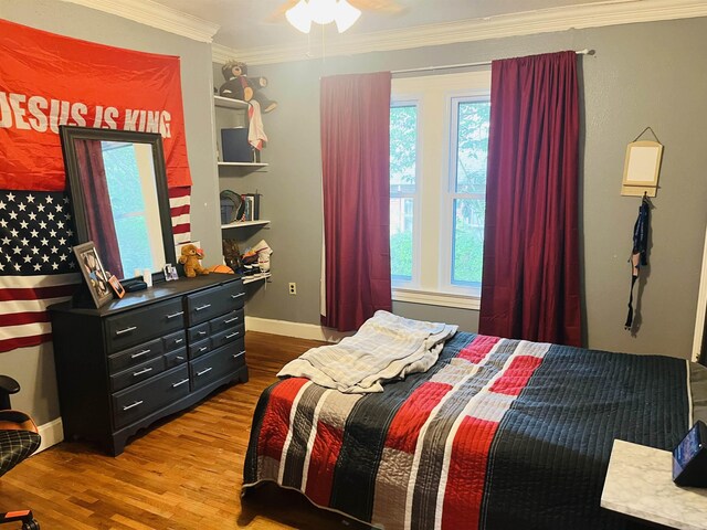 bedroom with ceiling fan, hardwood / wood-style flooring, and ornamental molding