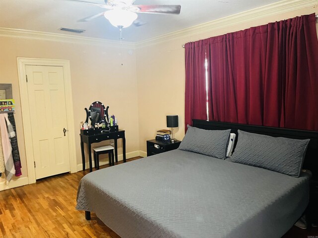 bedroom featuring ornamental molding, hardwood / wood-style flooring, and ceiling fan