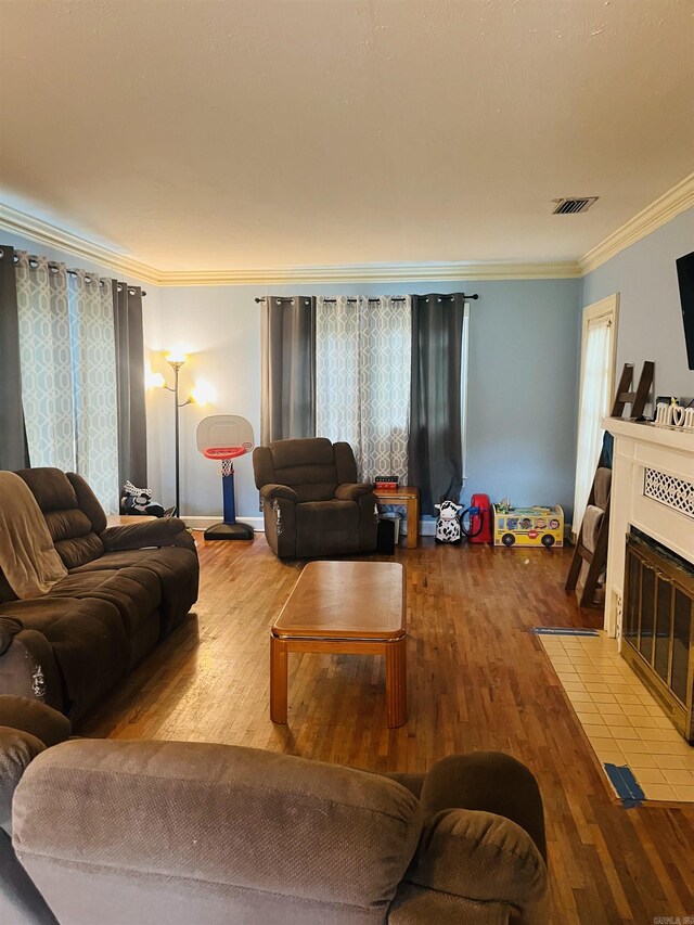 living room featuring ornamental molding and hardwood / wood-style floors