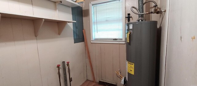 utility room with gas water heater and electric panel