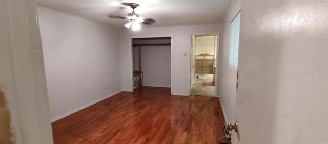 unfurnished bedroom with dark wood-type flooring and ceiling fan