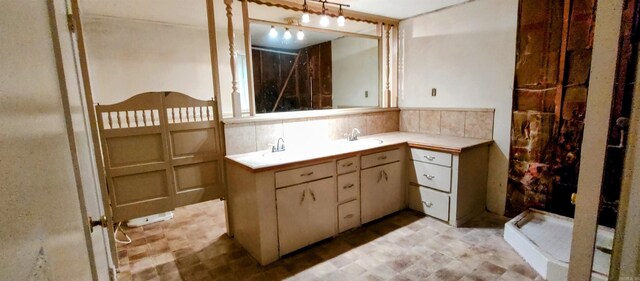 bathroom with tasteful backsplash, vanity, and a shower