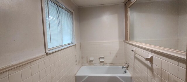 bathroom featuring a tub and tile walls