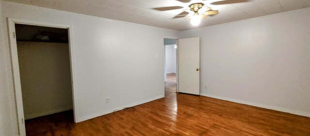 unfurnished bedroom featuring hardwood / wood-style floors, ceiling fan, and a closet