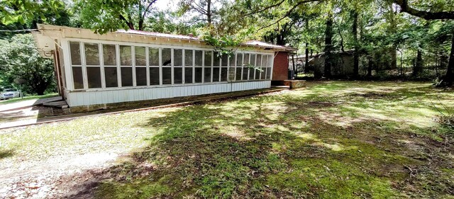 view of property exterior with a lawn