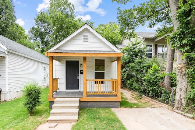 bungalow-style home with a porch and a front yard