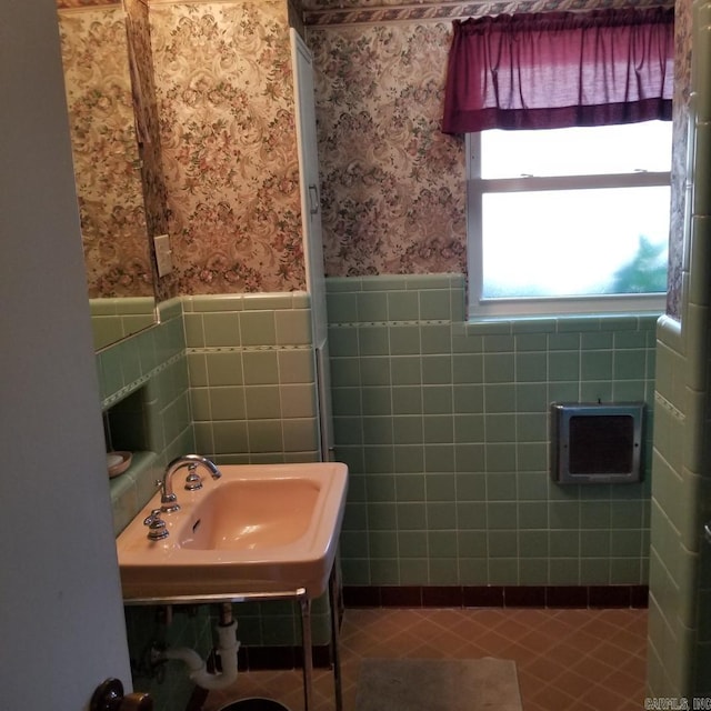 bathroom featuring tile walls and sink